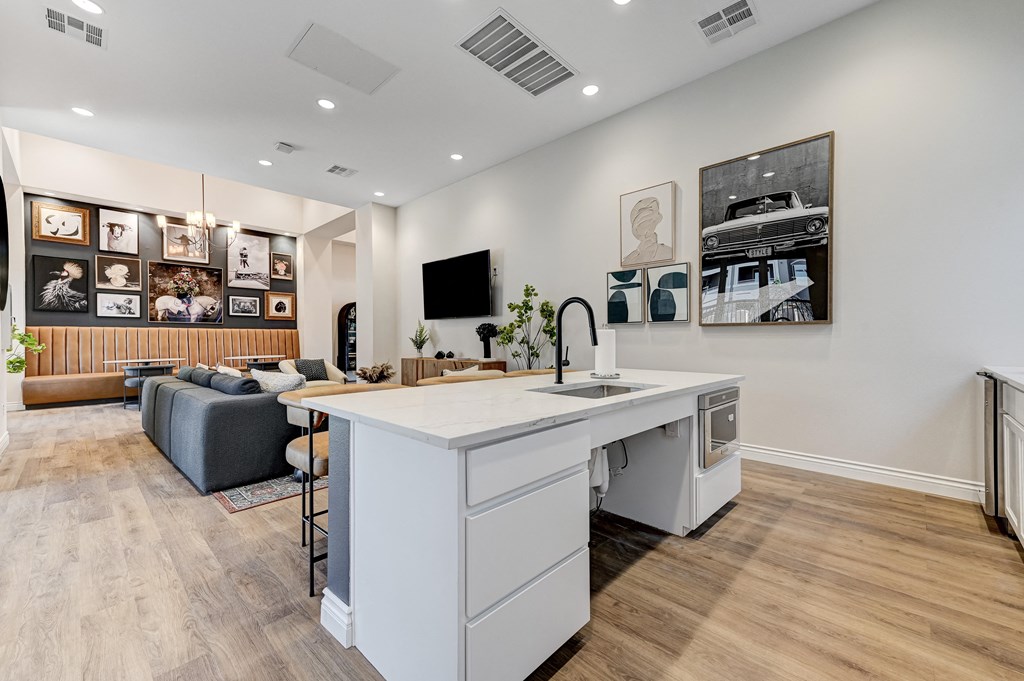 an open living room with a kitchen and a living room