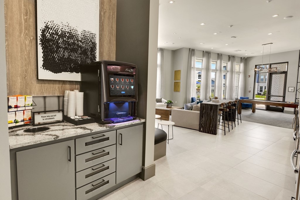 the lobby of a hotel with a coffee machine on the counter