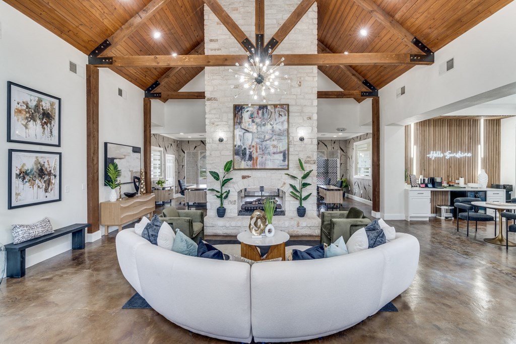 a living room with a large white couch and a fireplace