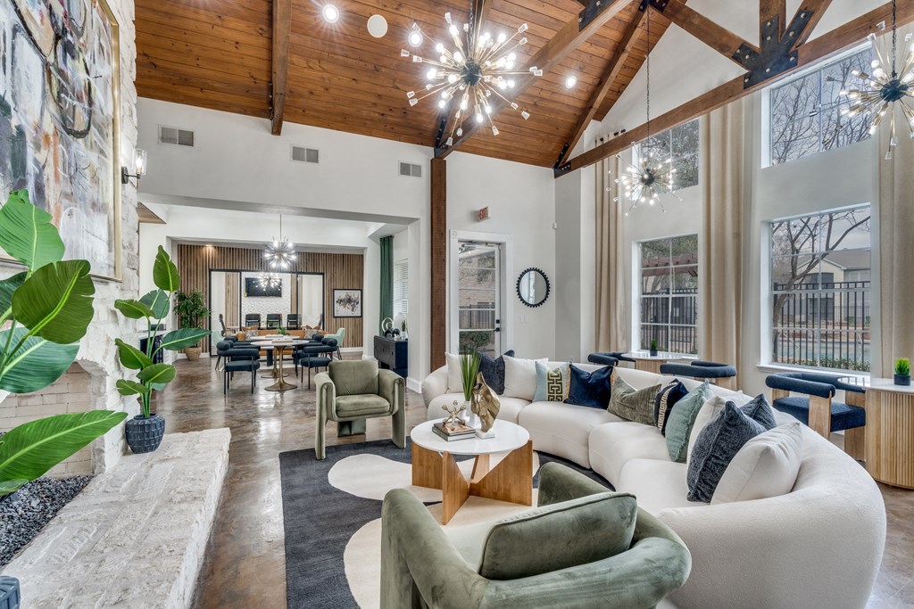 a living room with couches and chairs and a table