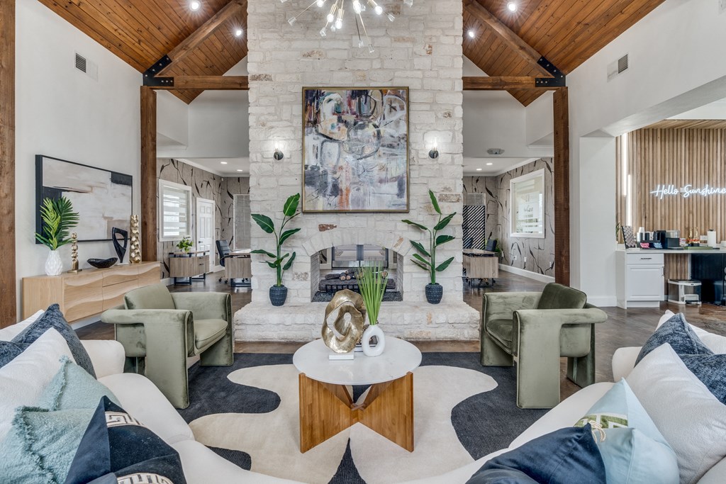 a living room with couches and chairs and a fireplace