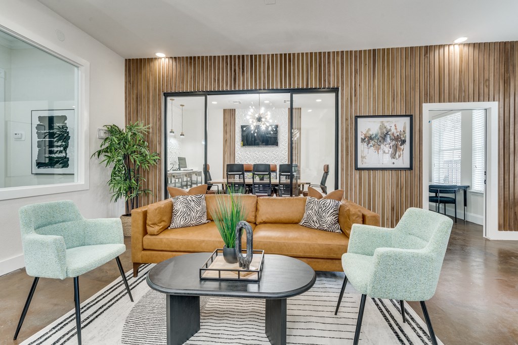 a living room with a couch and chairs and a table