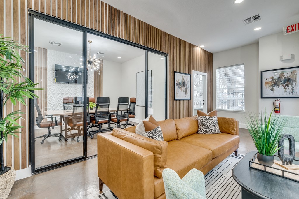 a living room with a couch and a table with chairs