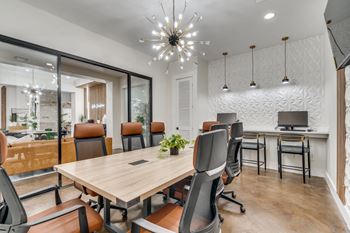 a conference room with a large wooden table and chairs