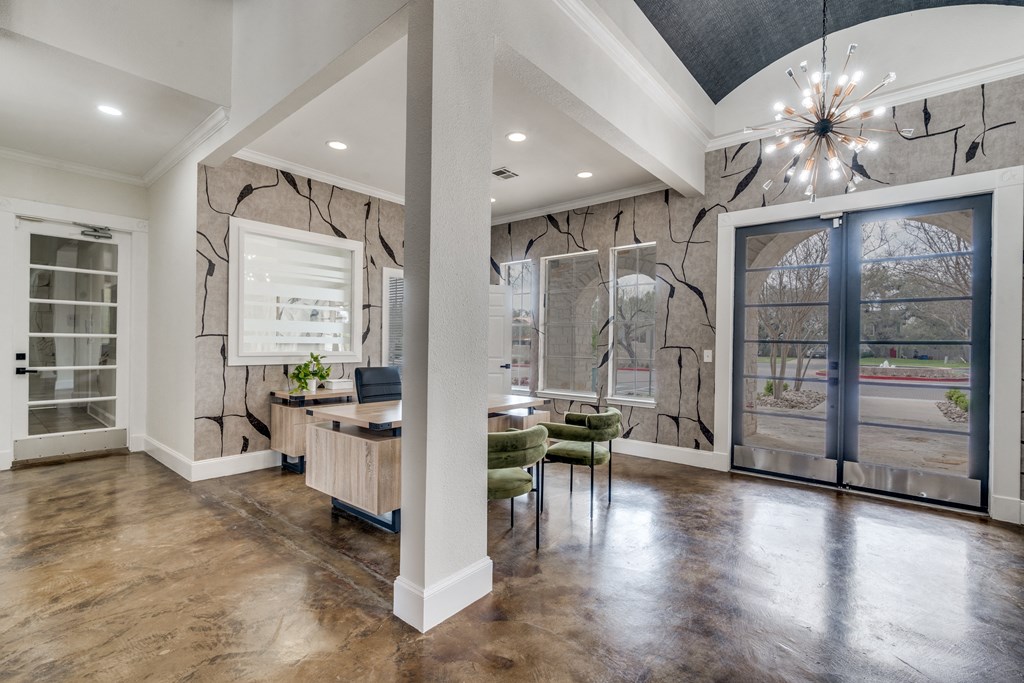 a dining room with a table and chairs and a large window