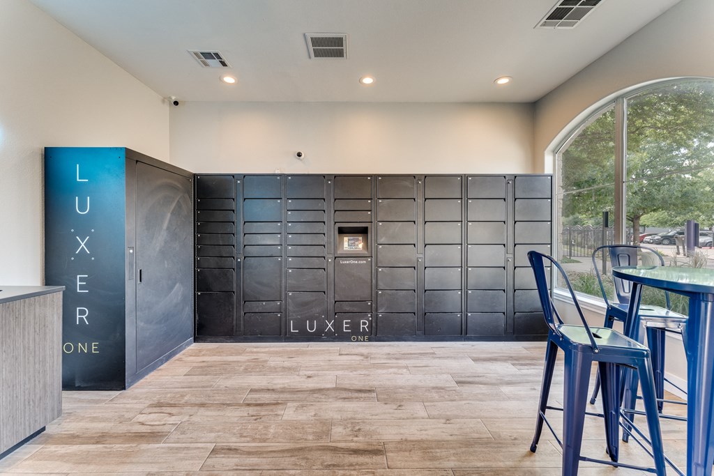 a bar with blue stools in front of a large metal locker door