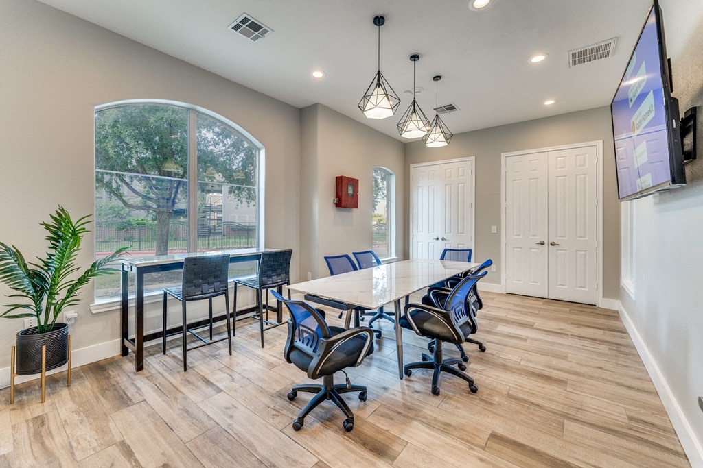 a conference room with a table and chairs and a large window