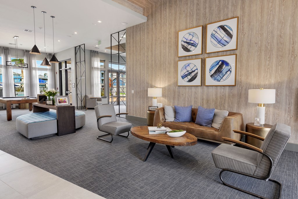 a living room with a couch and chairs and a table