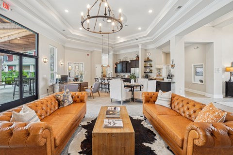 A living room with a brown leather sofa and a wooden coffee table.