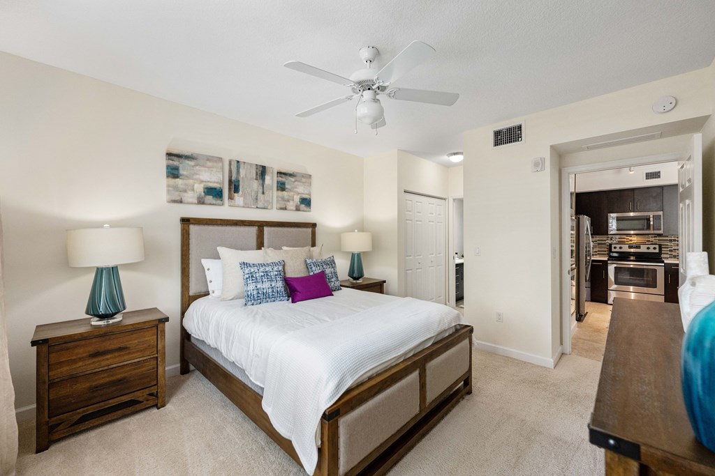 a bedroom with a large bed and a ceiling fan