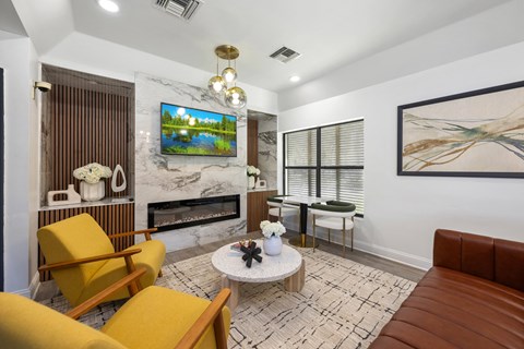 A living room with a fireplace, a TV, and a painting on the wall.