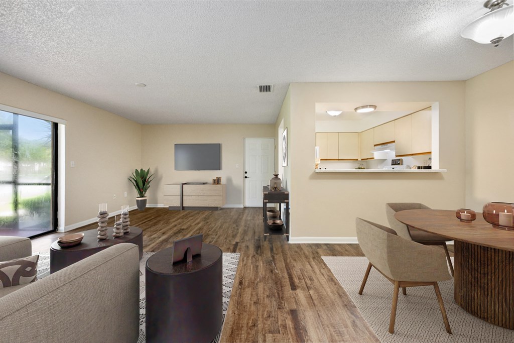 a living room and dining room with a table and chairs