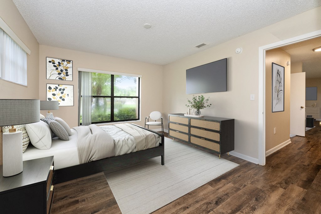 a bedroom with a large bed and a tv in a room