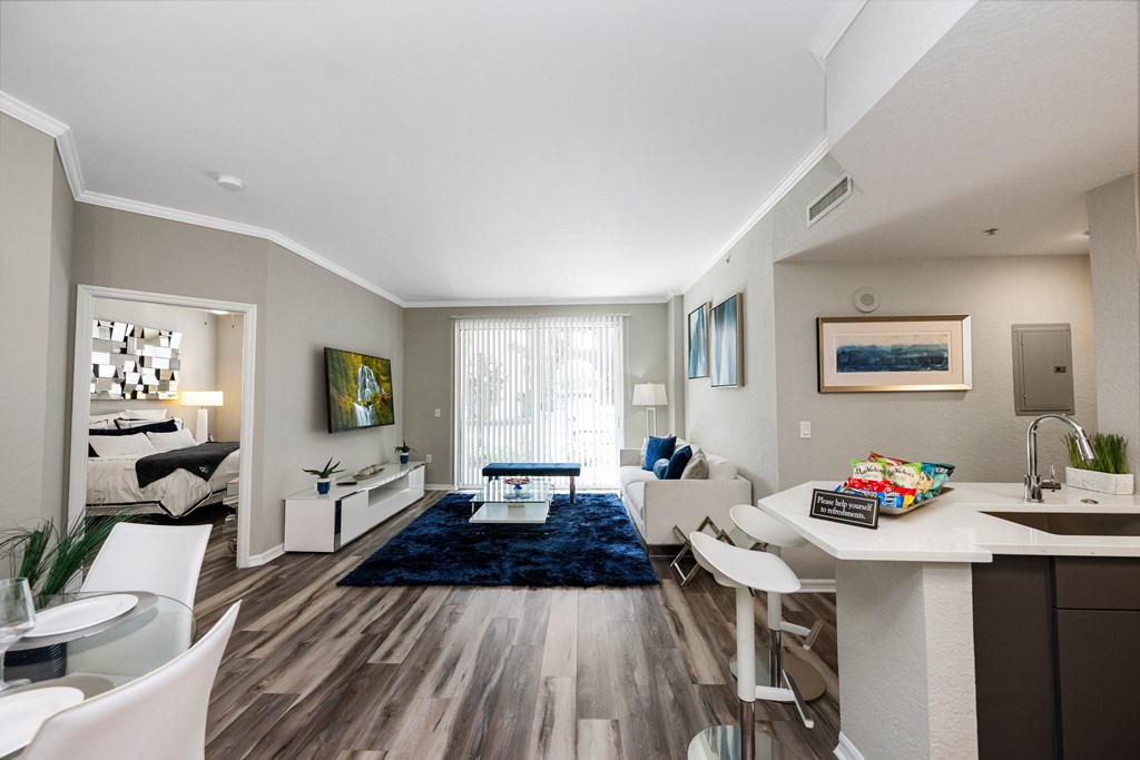 A modern kitchen with a dining table and chairs.