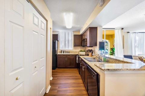 A kitchen with brown cabinets and a white door.