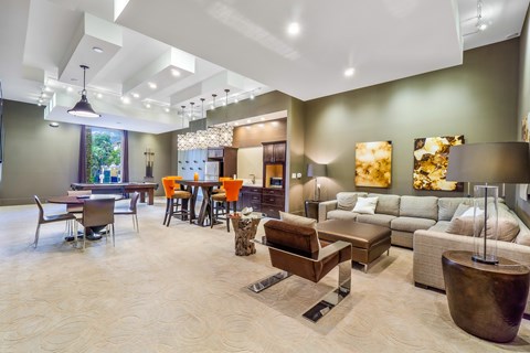 A spacious living room with a variety of furniture and decorative elements.