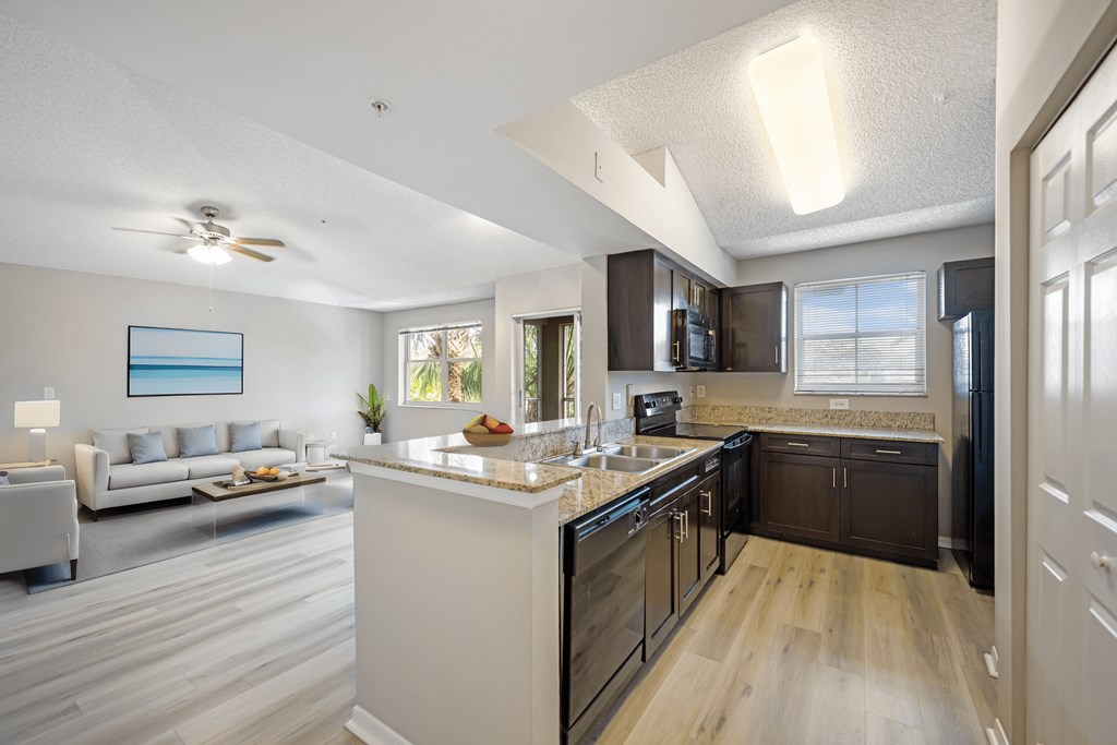 a kitchen with an island and a living room with a couch