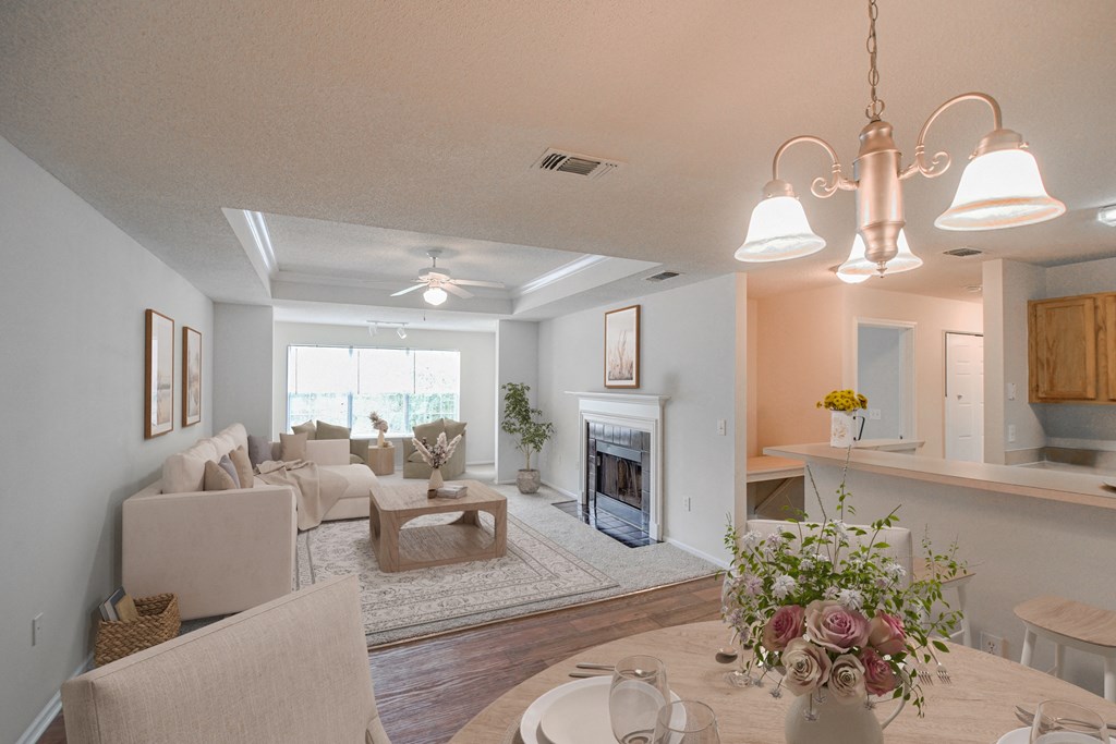 a living room with a fireplace and a dining table