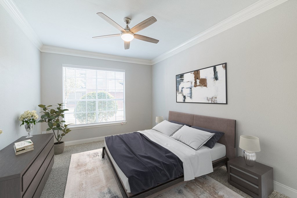 a bedroom with a bed and a ceiling fan