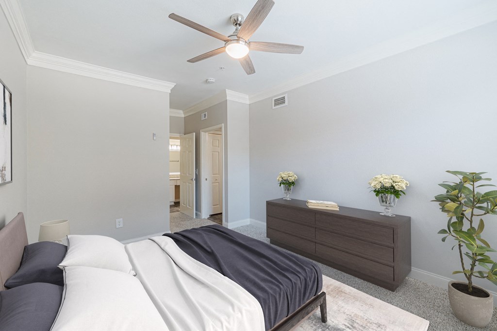 a bedroom with a bed and a ceiling fan