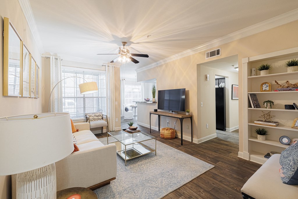 A living room with a white couch and a television.
