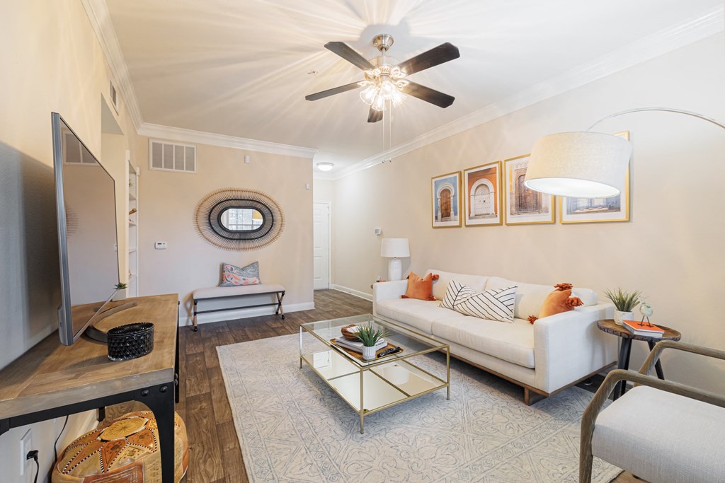 A living room with a white couch and a coffee table.
