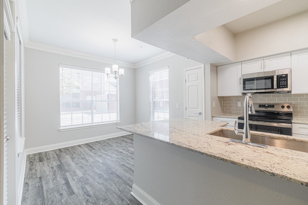 a kitchen with a marble counter top and a sink