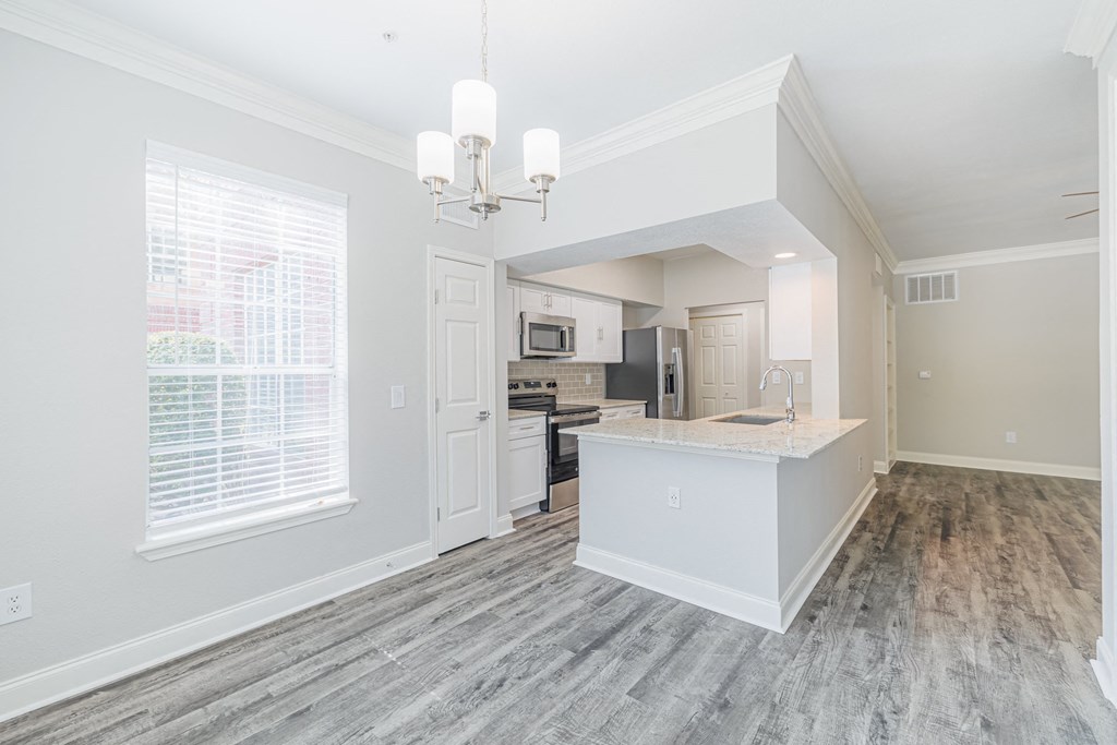 an open kitchen and living room with a large window