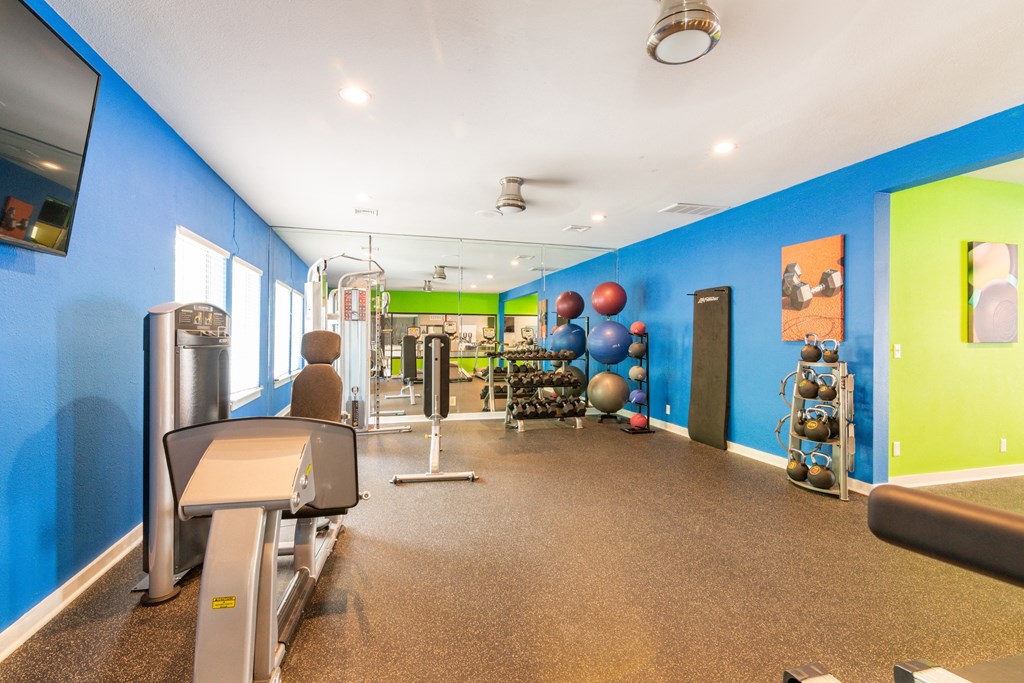 the gym at the enclave at woodbridge apartments in sugar land, tx