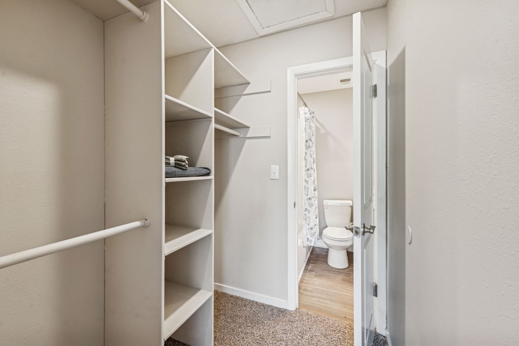 A white bathroom with a toilet and a white door.