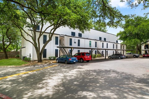 a large white building with cars parked in front of it