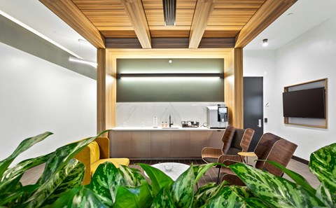 a living room with a table and chairs and a kitchen
