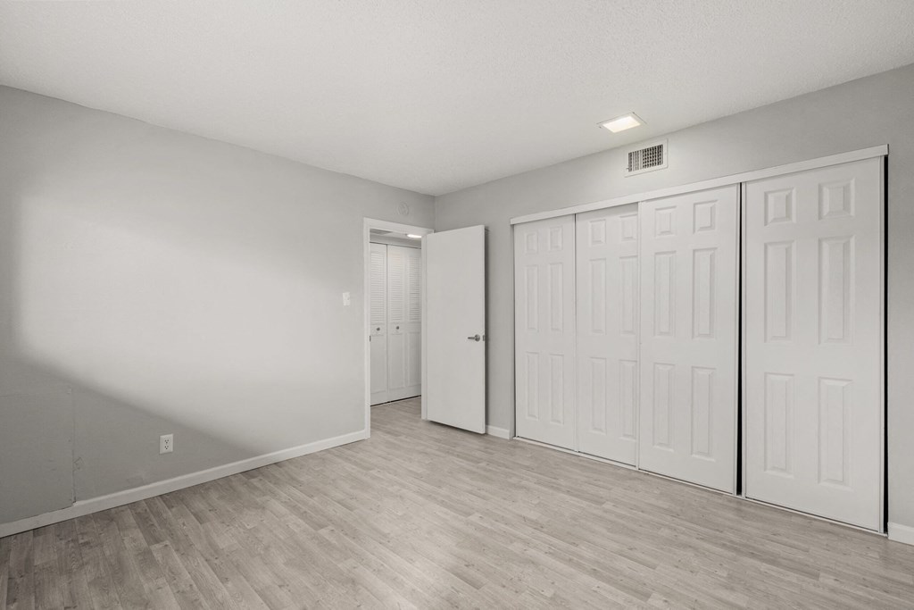 the living room of an empty apartment with white walls and doors