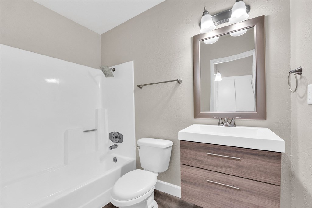 a bathroom with a toilet sink and bathtub