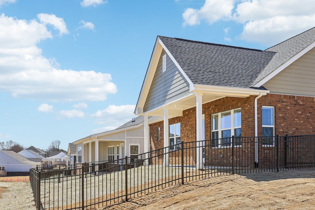 A house with a black fence in front of it.