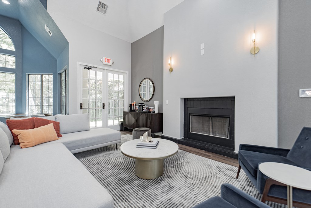 a living room with a white couch and a fireplace