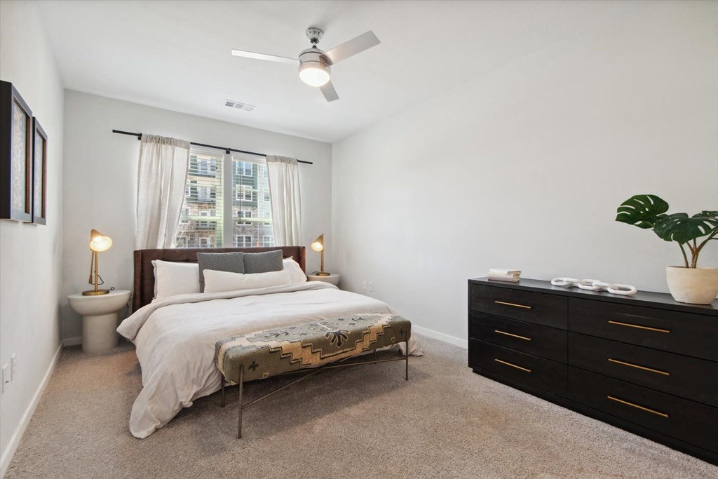 a bedroom with a bed and a dresser