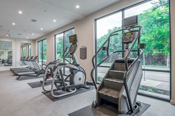 A gym with treadmills and elliptical machines.