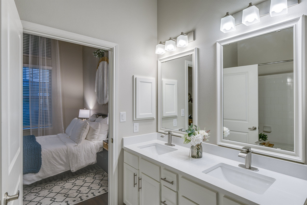 a bathroom with a large mirror and a sink