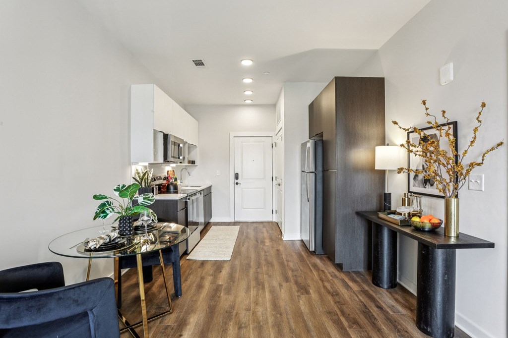 A modern kitchen with a glass table and chairs.
