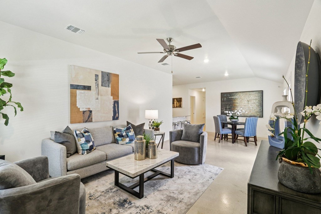 A living room with a grey couch and a coffee table.
