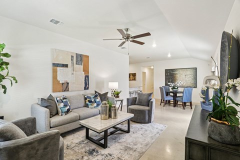 A living room with a grey couch and a coffee table.