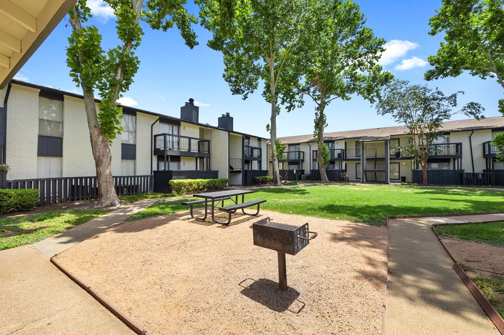 our apartments have a courtyard with a picnic table and a bench