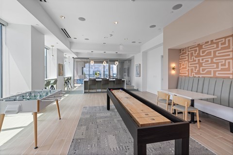 A modern living room with a long wooden table and chairs.