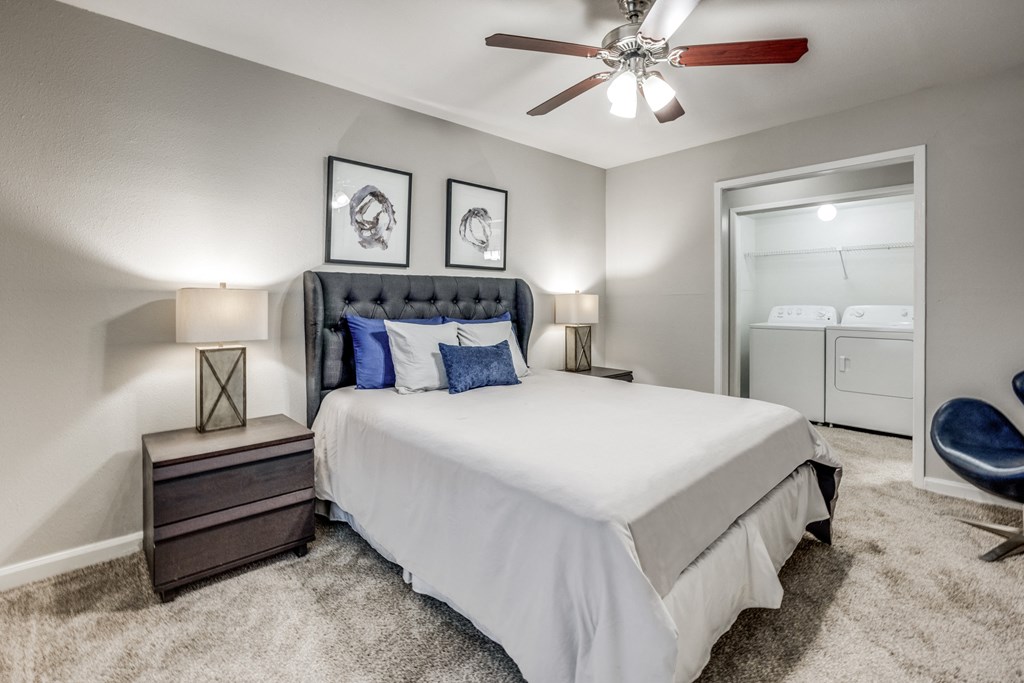 a bedroom with a bed and a ceiling fan