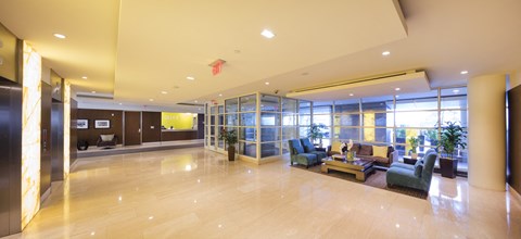 A spacious lobby with a large marble floor and a variety of seating options.
