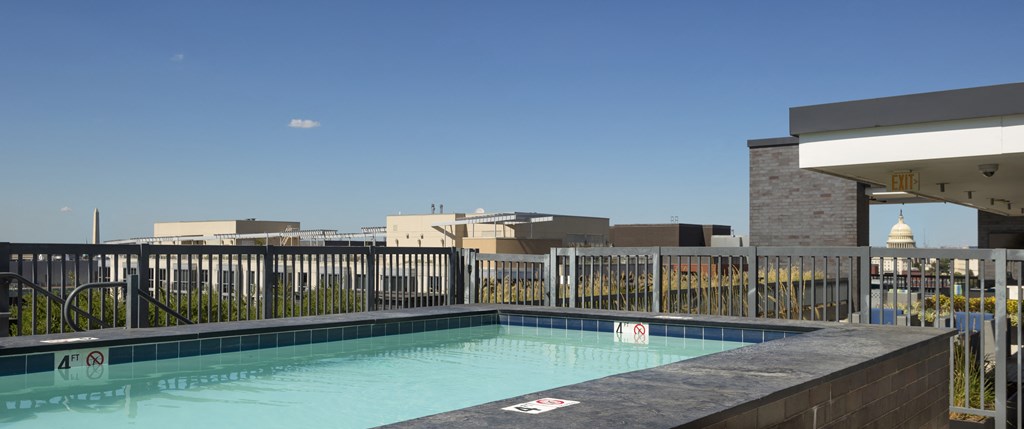 A pool with a blue tinted water with a white sign on the pool.
