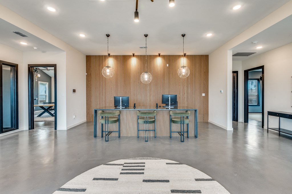 A modern room with a long table and chairs.