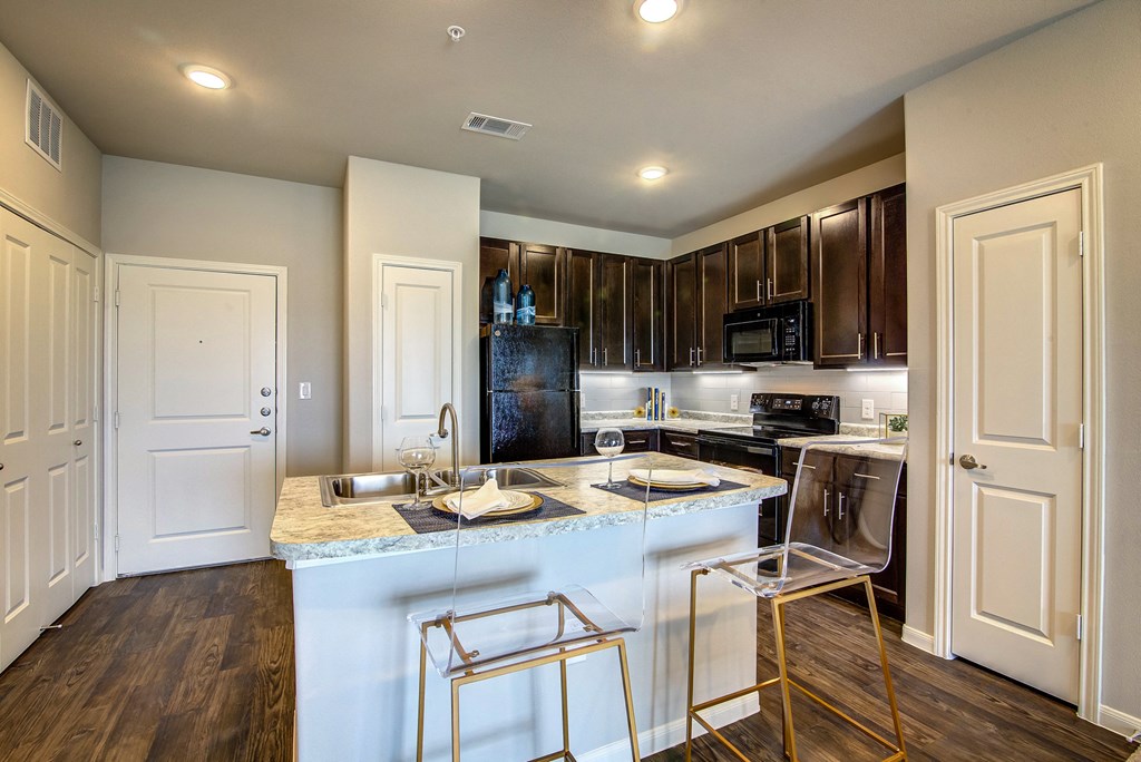 a kitchen with an island and stainless steel appliances