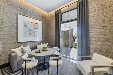 A modern dining area with a round table and chairs.